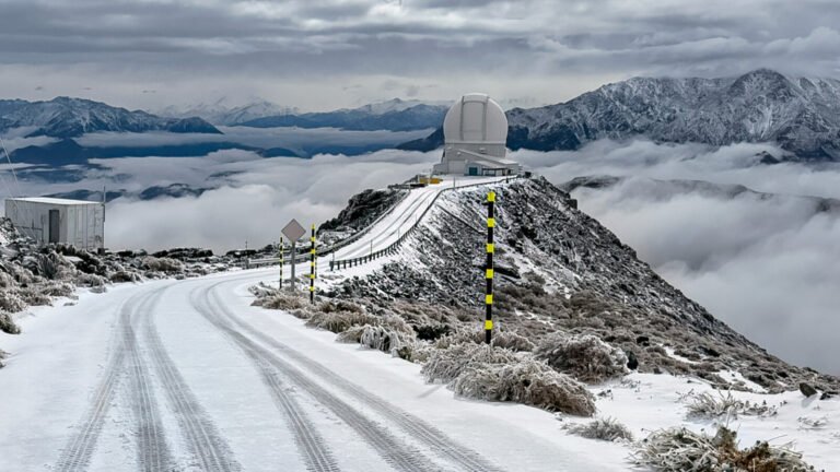 What a beautiful and unique photo! The SOAR Telescope, normally a stalwart observer of the night sky, is transformed into a winter wonderland scene, blanketed with a thick layer of snow. The usually-barren Chilean landscape is now a serene and peaceful expanse of white, with the telescope's dome and surrounding buildings peeking out from beneath the frosty covering.

The snow-covered peaks of the Andes Mountains rise up in the distance, a majestic backdrop for this unusual scene. The clear blue sky above adds a sense of depth and contrast to the photo, highlighting the stark beauty of the snow-covered telescope.

It's not often that we get to see astronomical observatories like SOAR in the midst of a snowstorm. Typically, these facilities are located in areas with clear skies and low humidity, making snow a rare occurrence. But here, the snow has brought a touch of magic to the normally-arid landscape, reminding us that even in the most unexpected places, beauty and wonder can be found.

The SOAR Telescope, operated by the Cerro Tololo Inter-American Observatory, is a 4.1-meter optical and infrared telescope that has been in operation since 2002. It's a versatile instrument, capable of conducting a wide range of astronomical research, from studying the formation of stars and galaxies to searching for exoplanets and understanding the properties of dark energy.

But on this day, July 11, 2025, the telescope is not focused on the distant reaches of the universe. Instead, it's simply enjoying the peaceful beauty of a snowy day, a rare and special treat in the Chilean desert.